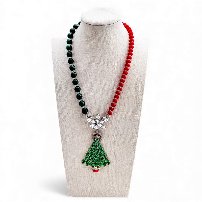 Necklace with green and red beads on a mannequin bust against a white background