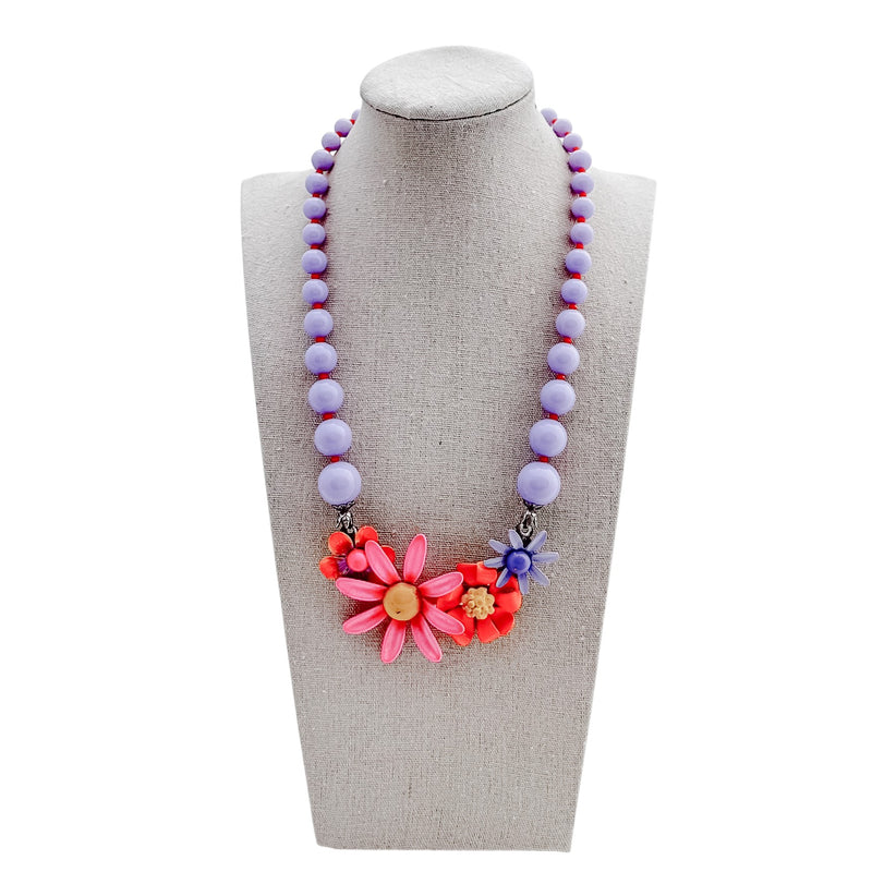 Necklace with colorful beads and flowers on a mannequin bust
