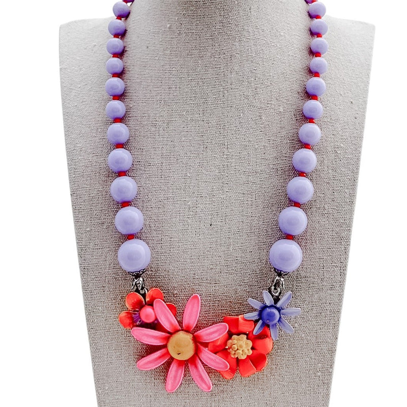 Necklace with colorful beads and flowers on a mannequin bust